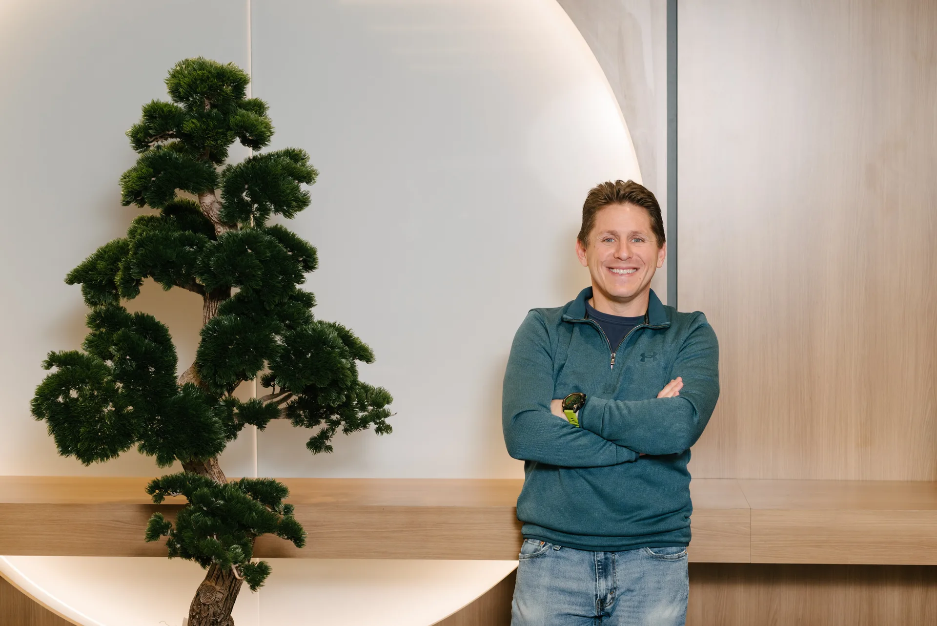 Quadshift team member standing with arms crossed