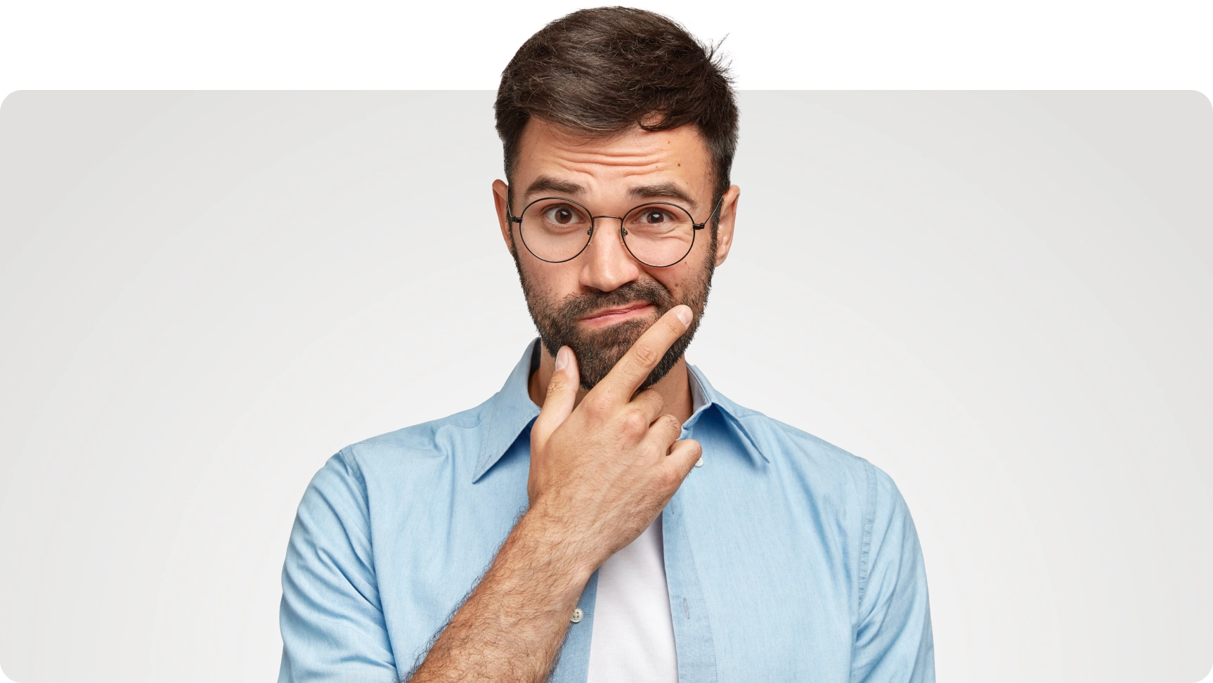 Reaction photo of a man raising an eyebrow in disbelief